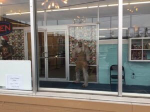 Explore iconic Star Trek artifacts and exhibits on a captivating museum tour -close up of characters at entrance dressed in christmas decorations