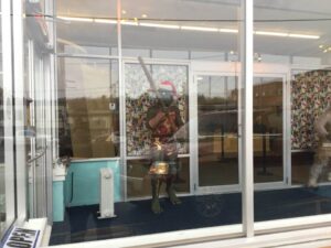 Explore iconic Star Trek artifacts and exhibits on a captivating museum tour -close up of characters at entrance dressed in christmas decorations