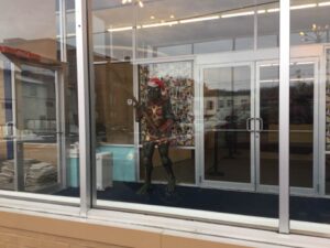 Explore iconic Star Trek artifacts and exhibits on a captivating museum tour -close up of characters at entrance dressed in christmas decorations